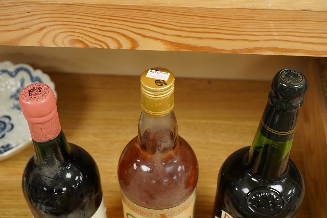 A bottle of Fonseca 1970 vintage port, a bottle of 1970 Chateau Grand-Puy-Lacoste, a litre bottle of Bounty rum and a litre bottle of Harvey’s Bristol Cream